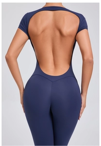 Detail of the open back design and V-shaped stitching on dark blue fitness bodysuit
