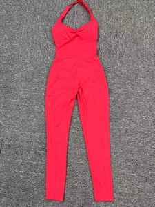 Detail view of pink halter neck yoga jumpsuit featuring pleated chest and high waist fit
