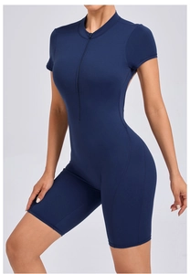 Close-up of dark blue short sleeve yoga romper with front zipper and flatlock stitching