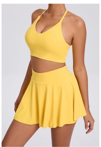 Detail of vibrant yellow tennis skirt and v-neck bra set with high elastic sports fabric