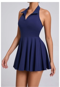 Detail of dark blue sports dress showing polo collar, halter cut and pleated skirt