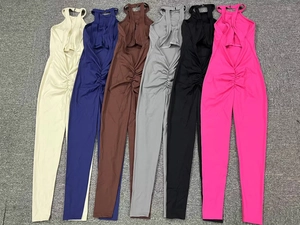 Detail view of colorful backless yoga jumpsuits featuring ruched front and hollow cutouts