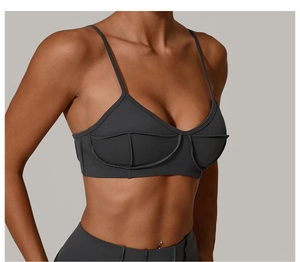 Detail view of charcoal gray sports bra with ultra-thin straps and contoured seams