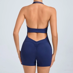 Back view of navy blue backless halter yoga romper with ruched bum lifting detail