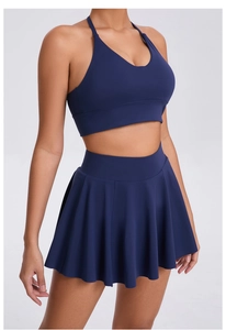 Detail view of navy blue high-stretch sports bra and pleated skirt set for tennis fitness