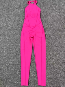 Close-up of bright pink yoga jumpsuit featuring halter neck and V-shaped waist stitching