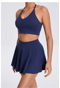 Detail of navy blue athletic tennis set with halter sports bra and pleated skirt