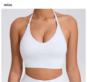 Detail view of white halter sports bra with a deep V-neck and wide elastic underband