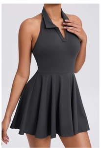 Detail of dark grey polo neck tennis dress with pleated skirt and athletic waist design