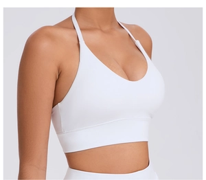 Detail of white yoga bra featuring adjustable straps and deep V-neckline for support