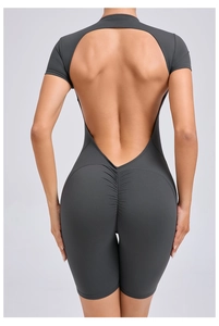 Detail view of ruched butt design and open back on dark grey fitness bodysuit