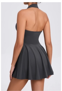 Back view of a charcoal grey halter neck sports dress with an open back and flared skirt