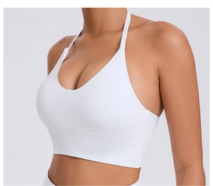 Close-up of white sports bra with adjustable straps and deep V-neckline for yoga