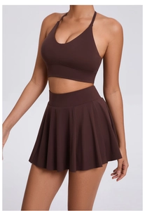 Detail of cross-back bra and pleated tennis skirt set in breathable coffee fabric