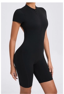 Detailed close-up of a black tight yoga bodysuit with half-zipper collar and elastic fabric