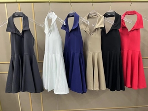 Detail view of colorful polo neck halter tennis dresses with pleated A-line skirts