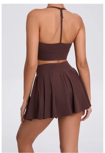 Back view of chocolate brown athletic set with racerback top and pleated tennis skirt