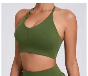 Detail of dark green V-neck sports bra with wide elastic band and ribbed fabric texture