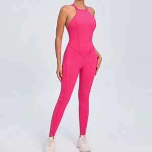 Backless halter neck yoga jumpsuit in vibrant pink with cutout back and slim fit pants