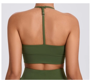 Detail of adjustable T-back straps with silver buckles on olive green sports bra