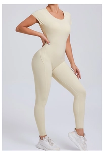 Detail of cream backless yoga bodysuit showing slim fit short sleeves and premium fabric