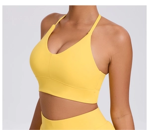 Close-up of bright yellow yoga sports bra with adjustable straps and V-neckline