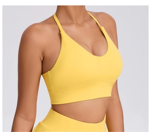Detail of bright yellow high-impact sports bra with deep V-neck and supportive wide band