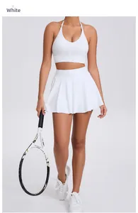 Detail of white halter sports bra and pleated tennis skirt set with quick-dry fabric