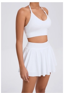 Close-up of white halter sports bra and pleated tennis skirt set for outdoor fitness