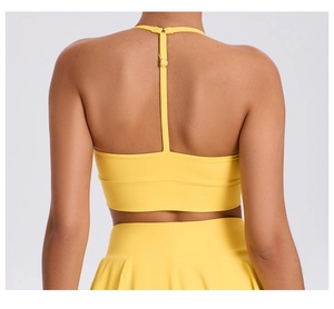 Detail of adjustable T-back straps on high-elastic yellow sports bra and skirt set