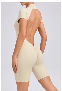 Detail view of ruched butt design and back cutout on the beige yoga bodysuit