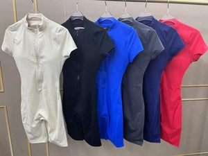 Detail showing various colors of short sleeve athletic rompers with half-zip collars