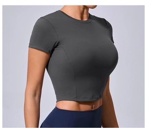 Side view of dark gray tight fit yoga t-shirt showing body contour and fabric stretch