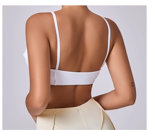 Detailed back view of white strappy yoga bra with U-shaped cut and smooth fabric