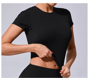 Stretch detail of black compression yoga crop top showing high elasticity and fabric texture