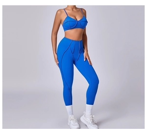 Detail of blue sports bra and high waist leggings set with purple contrast stitching