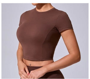 Detail view of high-elasticity dark brown crop top with professional sports stitching