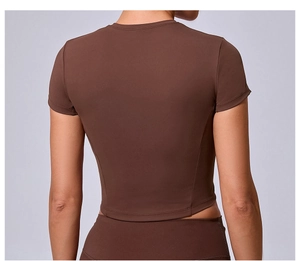 Rear view of tight-fitting dark brown yoga crop top with elastic sports fabric