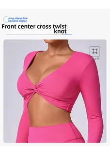 Detalle de camiseta de yoga rosa fucsia con escote en V profundo y nudo cruzado frontal