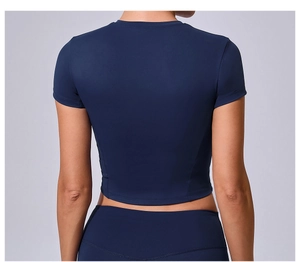 Rear view of tight dark blue short sleeve yoga top with reinforced stitching detail