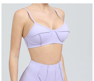 Detail view of purple sports bra with thin straps and matching high waist yoga leggings