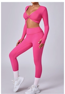 Detalle del conjunto de yoga rosa con top de cuello en V, nudo y puños con orificio