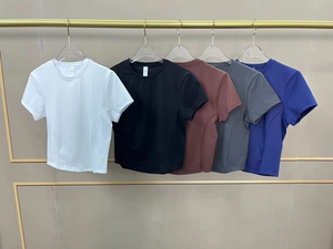 Close-up of slim fit athletic t-shirts in various colors with side contouring seams