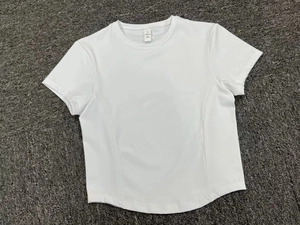 Detailed view of white quick-dry yoga t-shirt with curved seams and round neckline