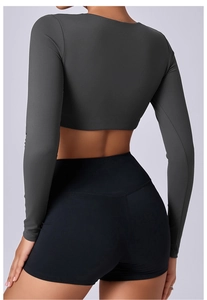 Rear view of tight cropped yoga long sleeve top and high waist shorts set