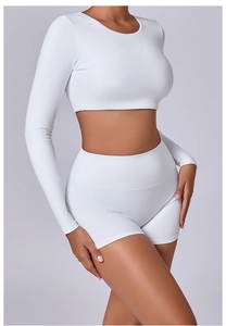 Detail view of white long sleeve crop top and high waist shorts gym set for women