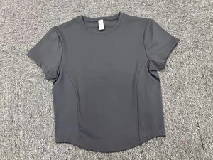 Detail view of dark grey athletic t-shirt showing size M tag and quick-dry fabric texture