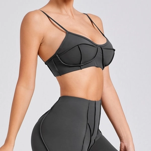 Women's charcoal grey sports bra and leggings set with thin straps and ribbed details