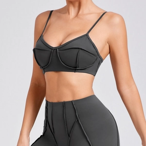 Deep grey yoga set featuring a thin strap sports bra and high-waisted leggings with seams