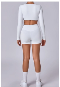 Rear view of white high-waist yoga shorts and long sleeve crop top fitness set